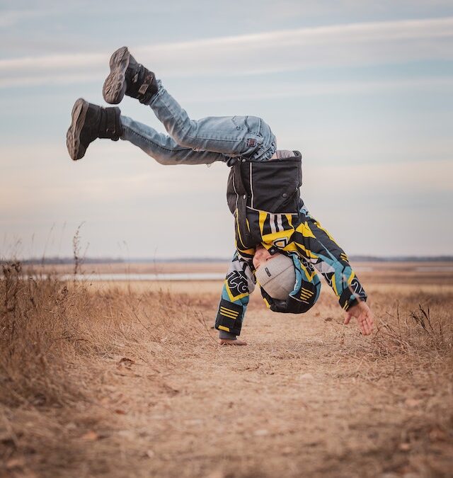 Boy joyfully executing a flip outdoors, symbolizing the rediscover childhood joy theme and the pure pleasure of the experience